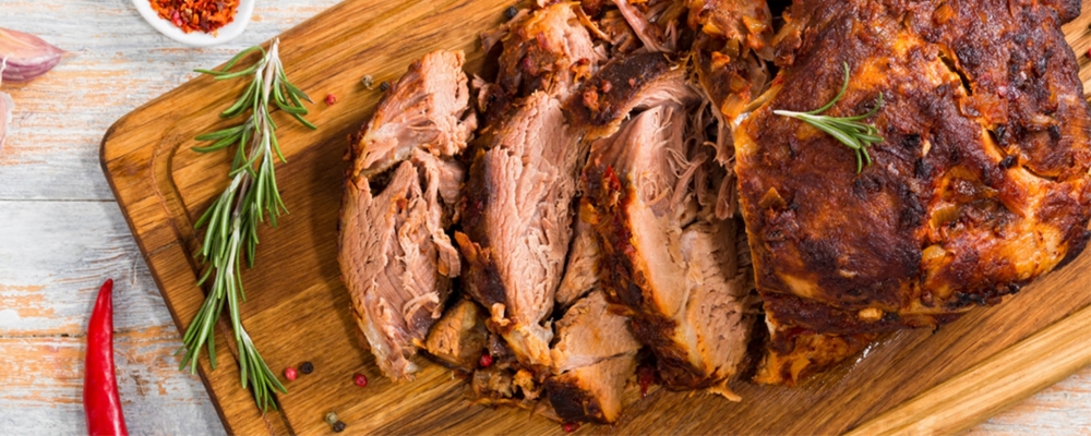 Pot-roasted shoulder of pork with an apple, celery and potato bake